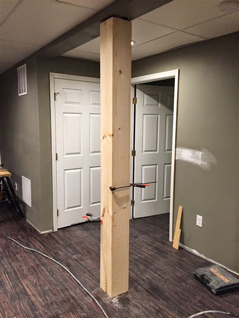 The use of the angled support beams and faux iron banding give this space a rustic quality. Over on Dover: A Post About A Post: Disguising A Basement ...
