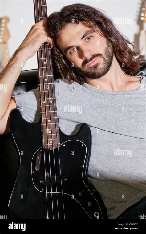 Portrait Of Young Man Holding Guitar Stock Photo Alamy