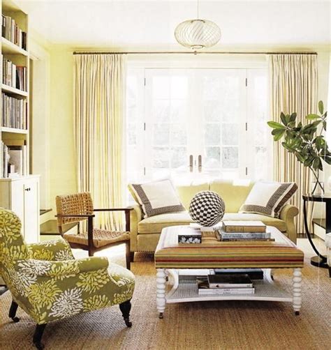 Transitional enclosed medium tone wood floor and brown floor family room photo in new york with white walls, a standard fireplace, a stone fireplace and a media wall. green & yellow coastal living room design with yellow ...