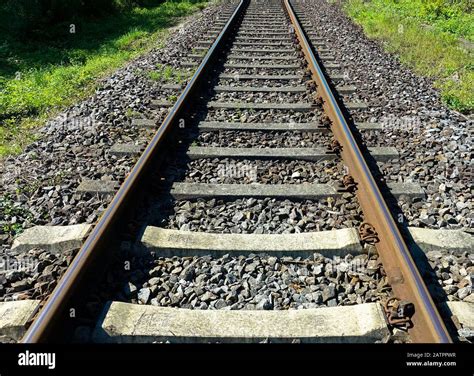 Railway Train Tracks In The Sunny Landscape Stock Photo Alamy