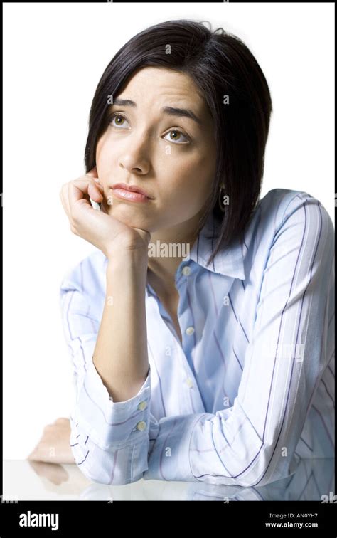 Close Up Of A Young Woman Thinking With Her Hand On Her Chin Stock