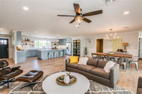 This is an example of a small contemporary open concept living room in london with black walls, dark hardwood floors and brown floor. 13 Trendy Open Concept Kitchen, Dining Room And Living Room