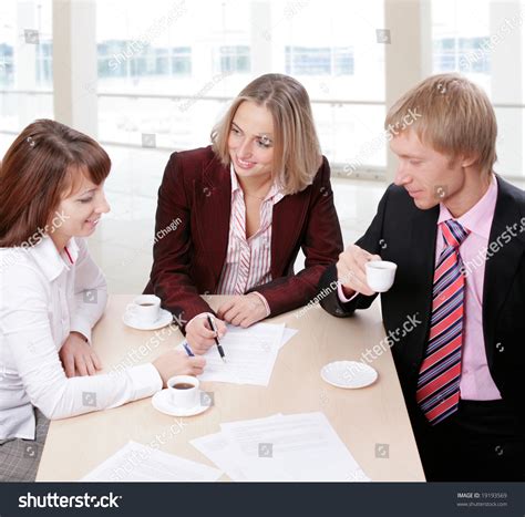 Three People Gathered Together Around The Table And Discuss Ideas At