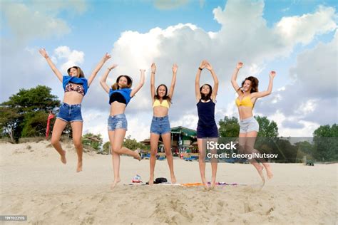 Five Beautiful Teenage Girls Having Fun Early In The Day On The Beach