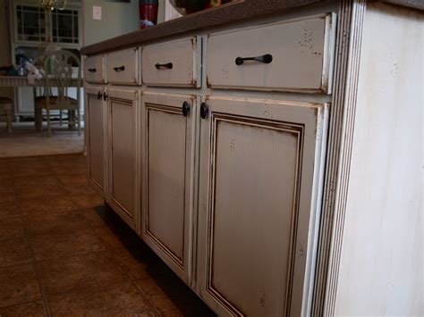 Painting over a dark finish with a light color is tougher and could require three coats. How to Paint and Antique Cabinets