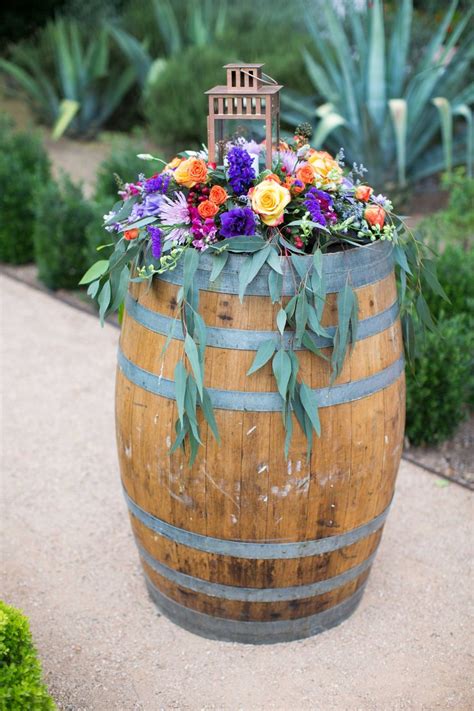 A Colorful Floral Arrangement Atop A Wine Barrel