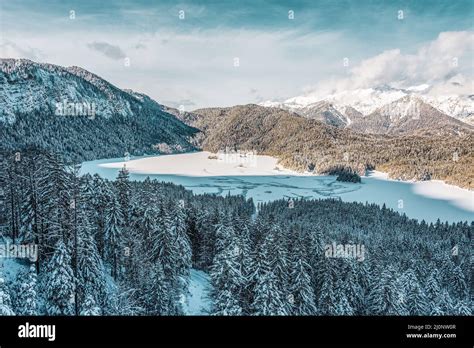 Snowy Mountains And Trees In The Alps View Of The Lake Eibsee Germany