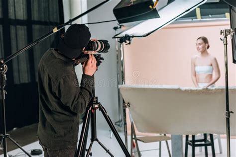 Selective Focus Of Videographer Filming Beautiful Female Model Stock