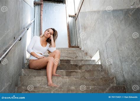 Beautiful Girl On The Stairs Of An Abandoned Building Stock Image