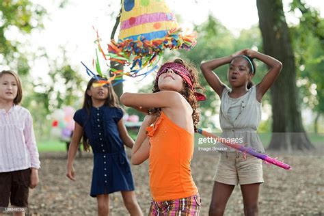 Girl At Birthday Party Hitting Pinata High Res Stock Photo Getty Images