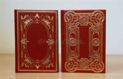 Two Red Cover Vintage Books Bound In Leather And Decorated With Gold