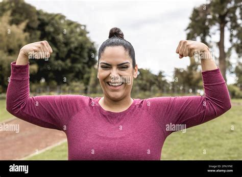 Curvy Woman Smiling On Camera While Doing Jogging Routine Outdoor At City Park Focus On Face