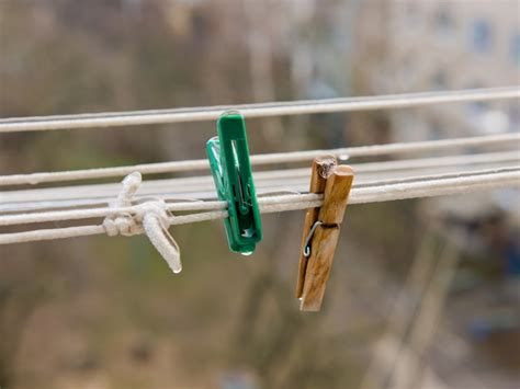 premium photo two clothespins on a clothesline covered with ice
