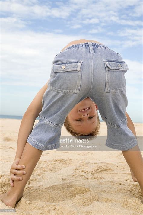 Boy Bending Over On Beach High Res Stock Photo Getty Images