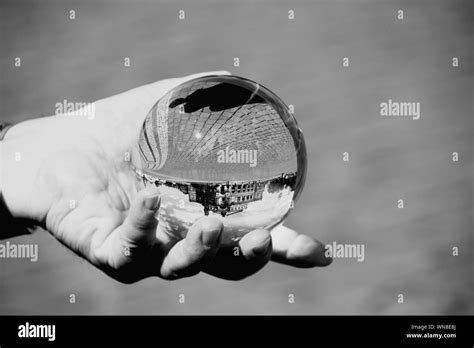 Close Up Of Human Hand Holding Crystal Ball On City Street Stock Photo
