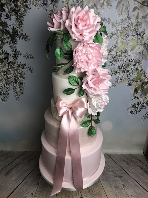 When thinking about wedding cake designs, some couples want nothing to do with the ordinary. Cascading Sugar Flower Wedding Cake - Mel's Amazing Cakes