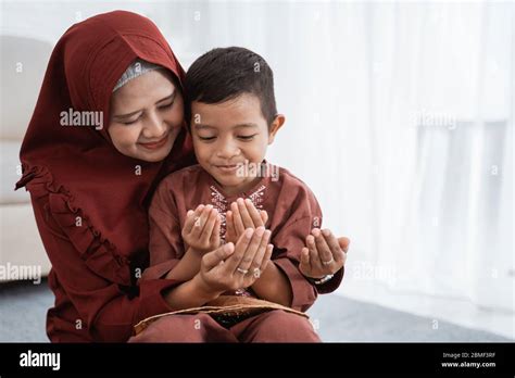 Muslim Mother And Son Praying Together At Home Stock Photo Alamy