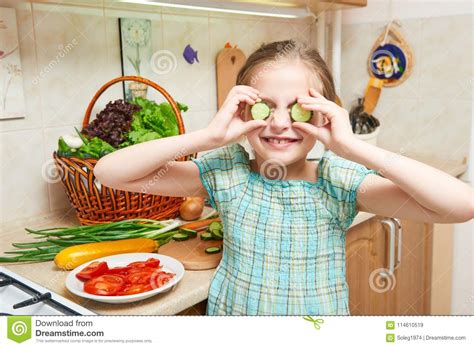 Girl Closes Her Eyes With Cucumbers And Have Fun In Home Kitchen