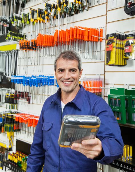 Worker With Arms Crossed In Hardware Shop Stock Photo Image Of Choice