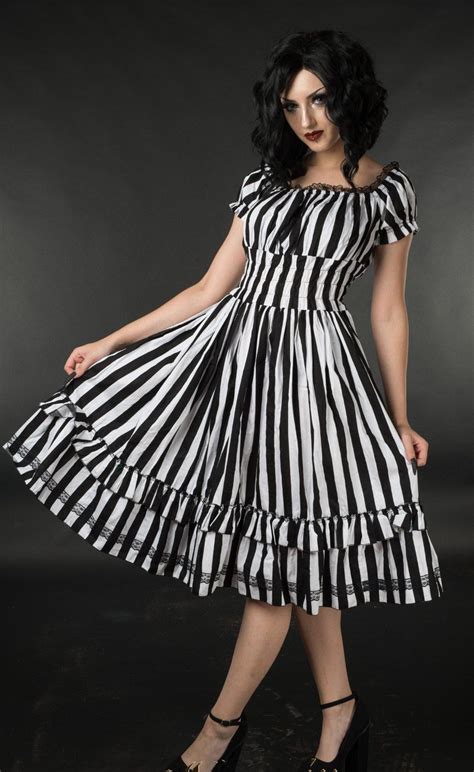 this lovely gothabilly dress features an eye catching black and white vertical stripe design