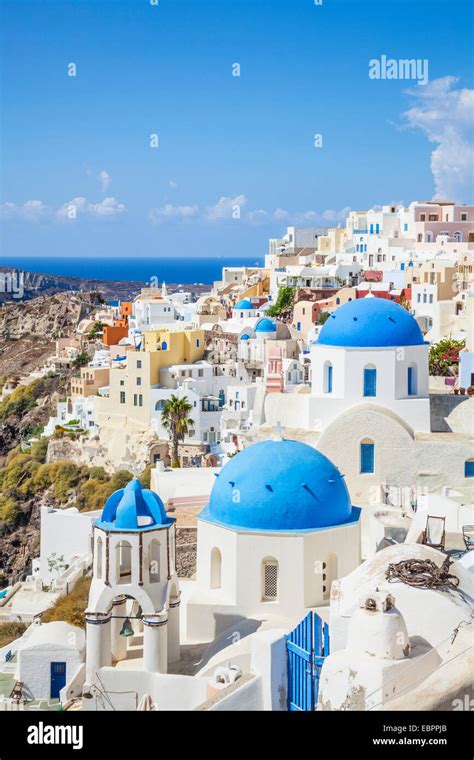 Greek Church With Three Blue Domes In The Village Of Oia Santorini