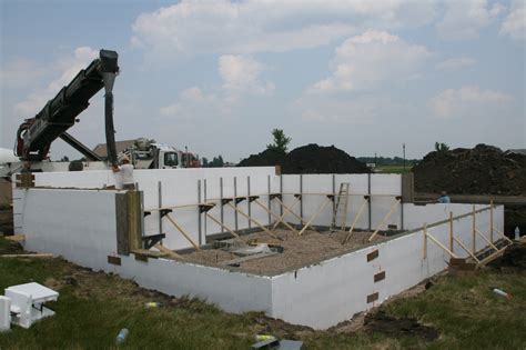 Concrete Is Being Poured Into The Wall Forms Made By The Rigid Foam