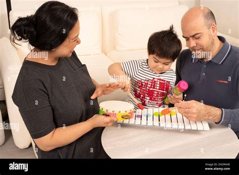 2 Year Old Toddler Boy Playing Wooden Xylophone With A Mallet Mother