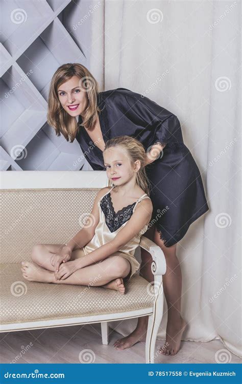 Mother And Daughter Alone At Home Beautiful Fashionable And Fun Stock