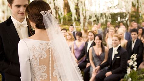 Below, the twilight wedding dress details — the back of the bridal gown feature a row of 152 buttons and sheer panel framed with delicate embroidery. Bella Swan's Twilight Wedding Dress Is Up For Auction