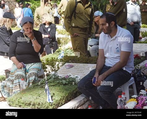 An Israeli Soldier Sits By The Graves Of Fallen Soldiers In The Mt