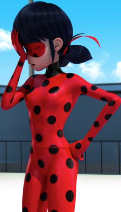 A Woman In A Red And Black Polka Dot Bodysuit With Her Hands On Her Head