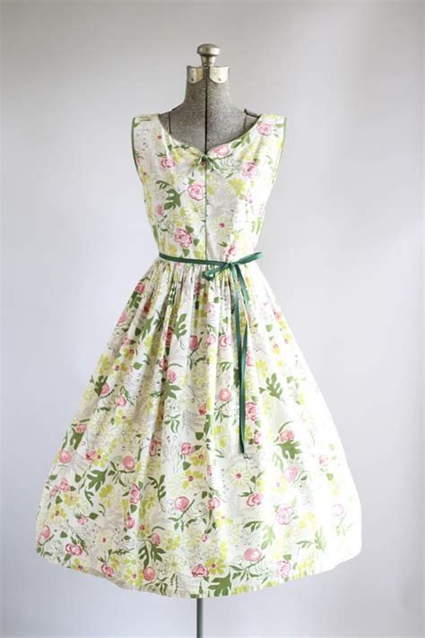 this 1950s cotton dress features a gorgeous floral print in shades of green pink red and