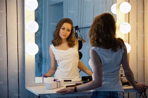 beautiful girl looking in the mirror high quality people images ~ creative market