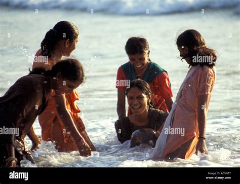 Young Indian Women Bathe In Sea Wearing Saris Gokarna Karnataka
