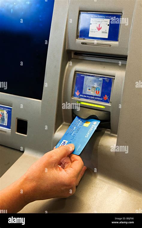 Inserting Debit Card Into Bank Atm Germany Stock Photo Alamy