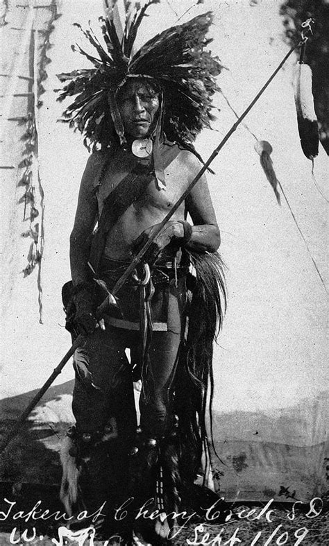 an old black and white photo of a native american man