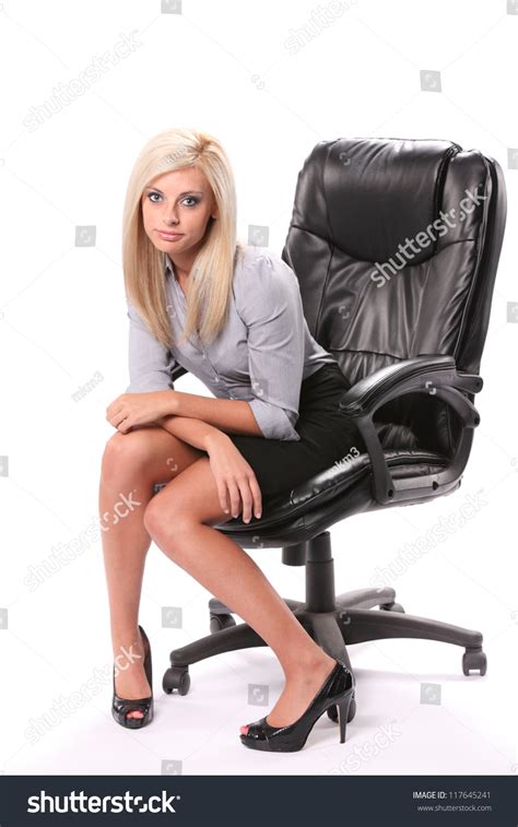 A Tired Business Woman Sitting In A Swivel Chair Facing Front In A