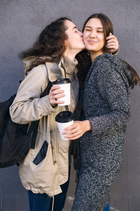 Two Young Girlfriends Hugging And Kissing Del Colaborador De Stocksy
