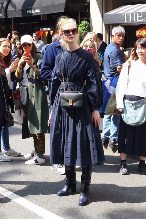Elle Fanning Looks Pretty In A Long Sleeved Navy Blue Dress While