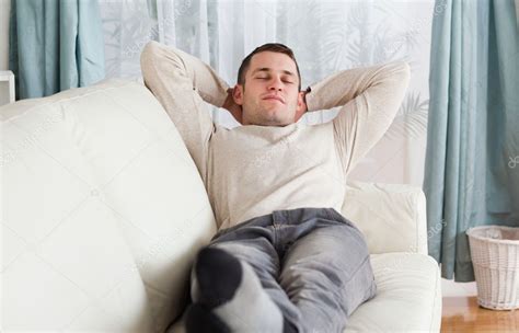 Young Man Resting On A Sofa — Stock Photo © Wavebreakmedia 11197146