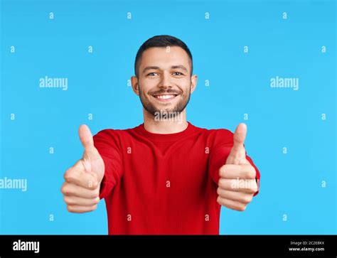 Happy Handsome Man Showing Thumbs Up Sign On Blue Background Stock