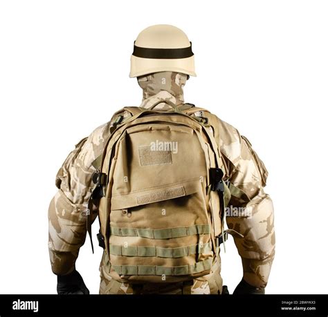 isolated photo of a fully equipped soldier in uniform armor helmet and backpack standing rear
