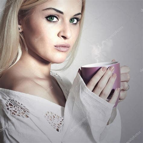beautiful blond woman drinking coffee vapor cup of tea hot drink girl in the morning — stock