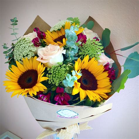 Bouquet of flowers wrapped in paper. Celebration Wrapped Bouquet in Downey, CA | Chita's Floral ...