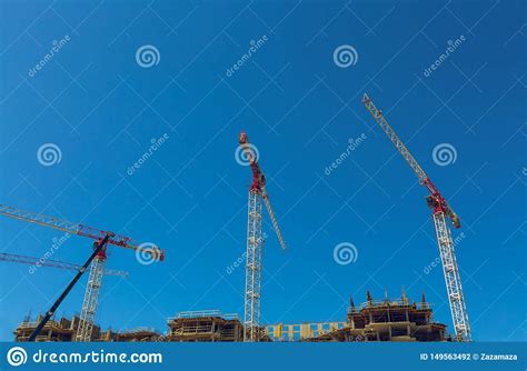 Large Construction Site Including Several Cranes Working On A Building