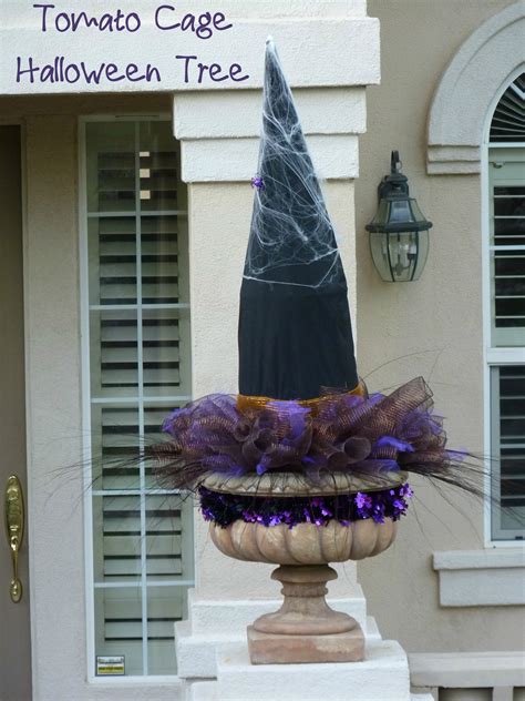 A black halloween tree with gold garlands, with a stand with black, white and gold pumpkins under it. Tomato Cage Halloween Trees