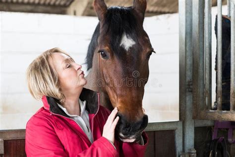 Mature Female Owner In Stable With Horse Stock Image Image Of