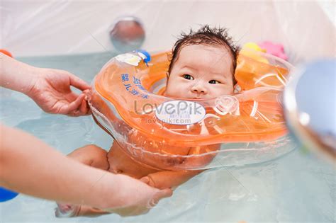 Baby Taking A Bath With A Swim Ring Picture And Hd Photos Free