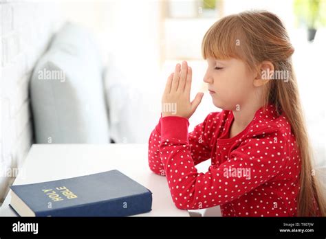 Little Girl Praying At Home Stock Photo Alamy