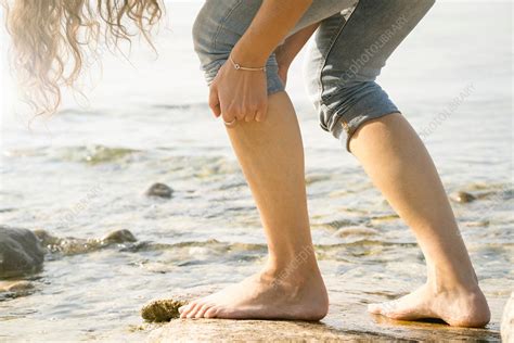 Cropped View Of Woman Barefoot On Rocks Stock Image F0219007